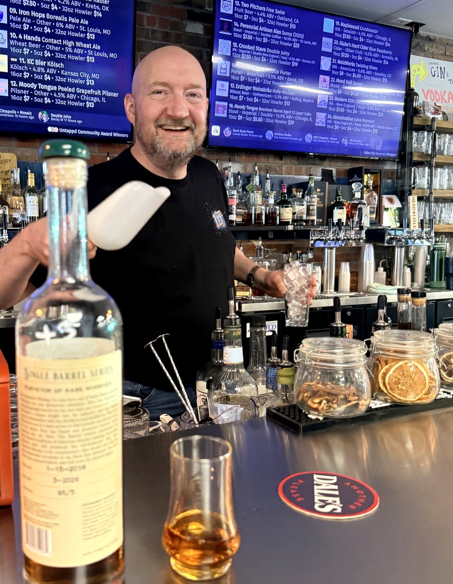 Steve at The Brothers Beer & Bourbon House, scooping ice behind the bar with the Rare Character Single Barrel Series rye bottle in the foreground showing the 95/5 mash bill back label, and the Hound's Glencairn pour on the bar.